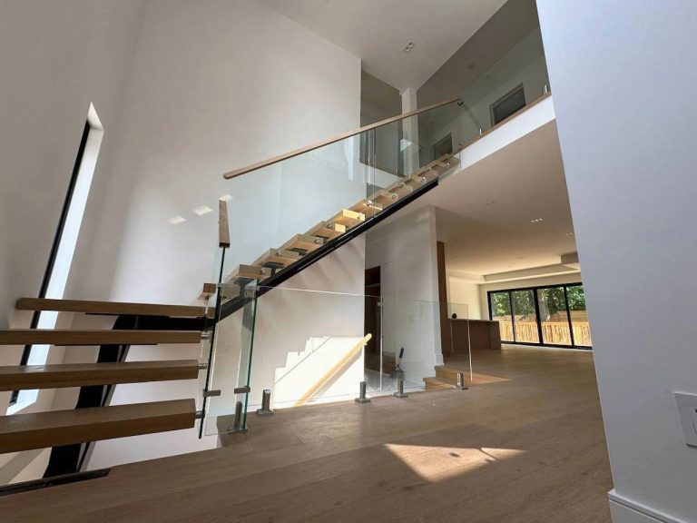 Interior Glass Stair And Landing Railing With Wood Top Rail